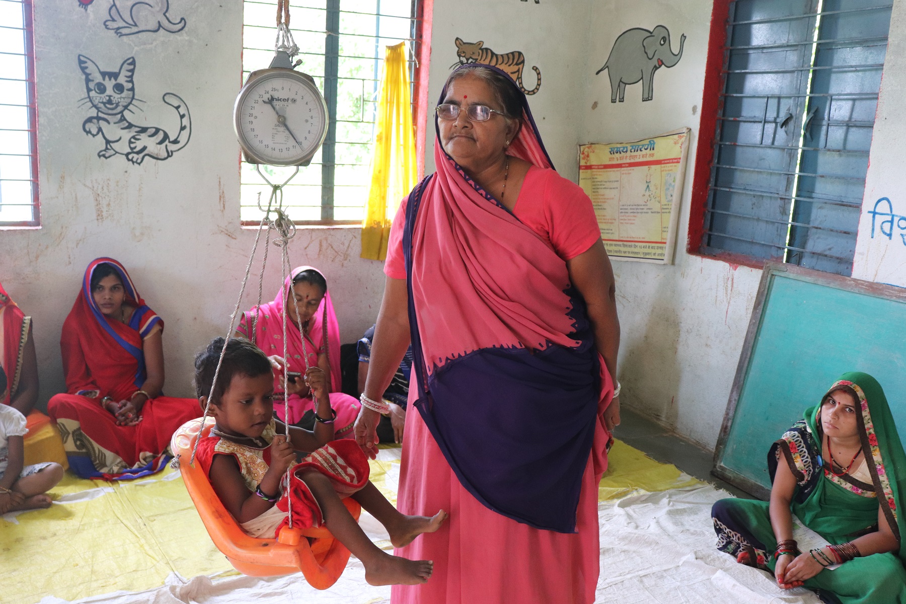 Children being weighed at the Anganwadi.