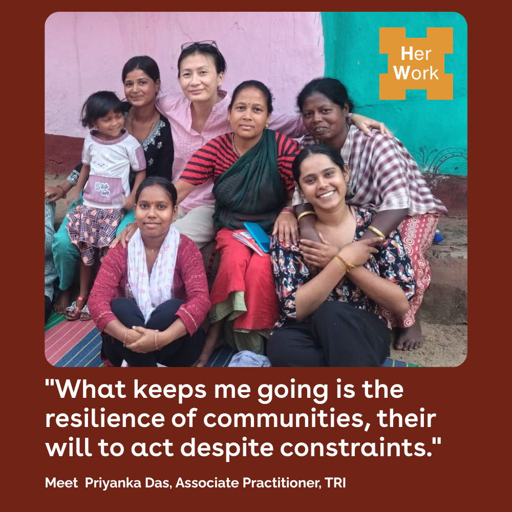 Group of women and a child sit together, smiling, with a 'Her Work' logo in the top-right and the quote about resilience displayed below.