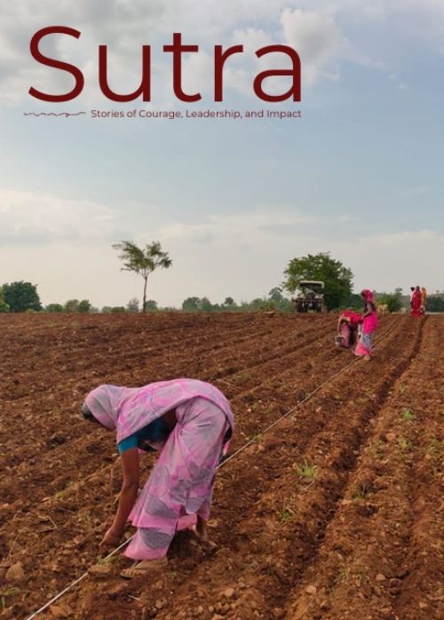 Sutra magazine cover showing women in pink traditional attire planting crops in a brown plowed field under a blue sky, with a distant tractor.